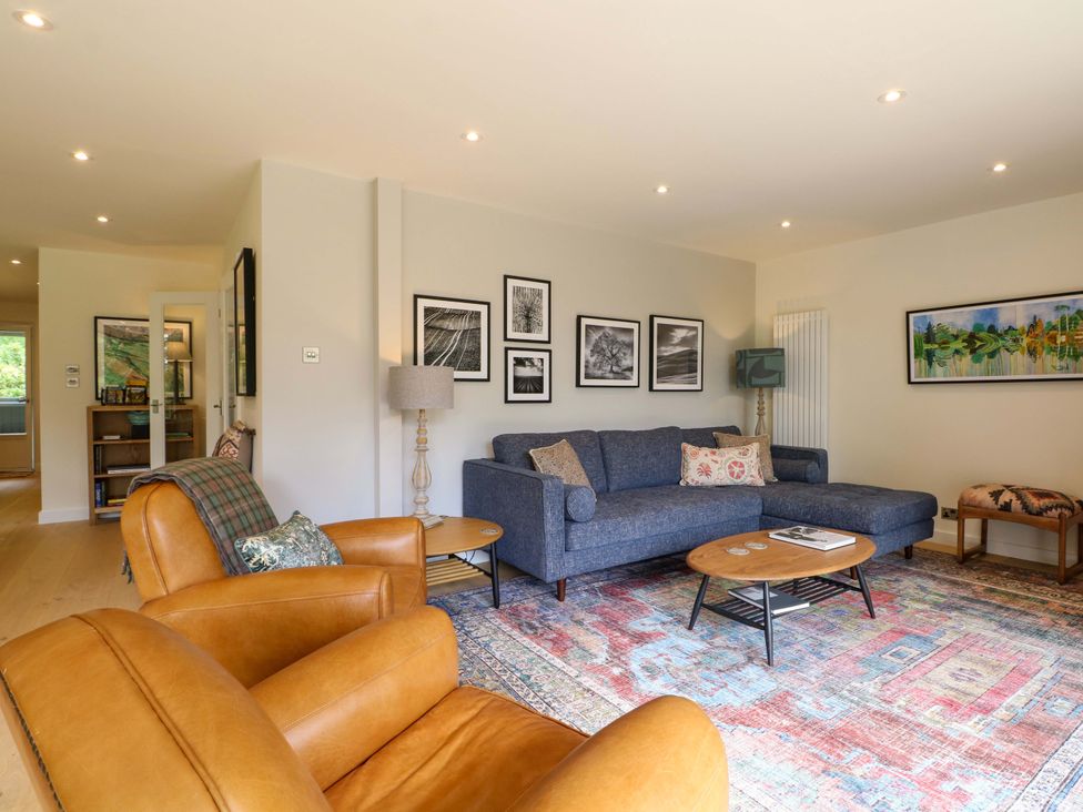 A living room with a sofa and chair at Lakeside Lodge in Witherenden Hill near Burwash