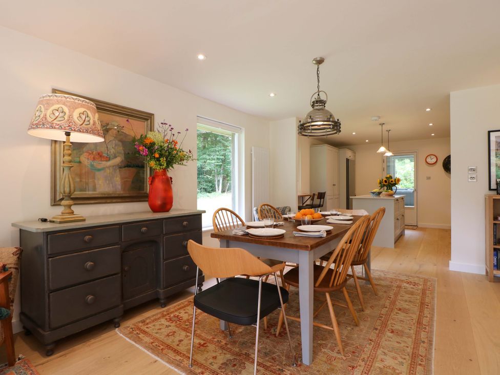 A dining room with table and chairs at Lakeside Lodge in Witherenden Hill near Burwash