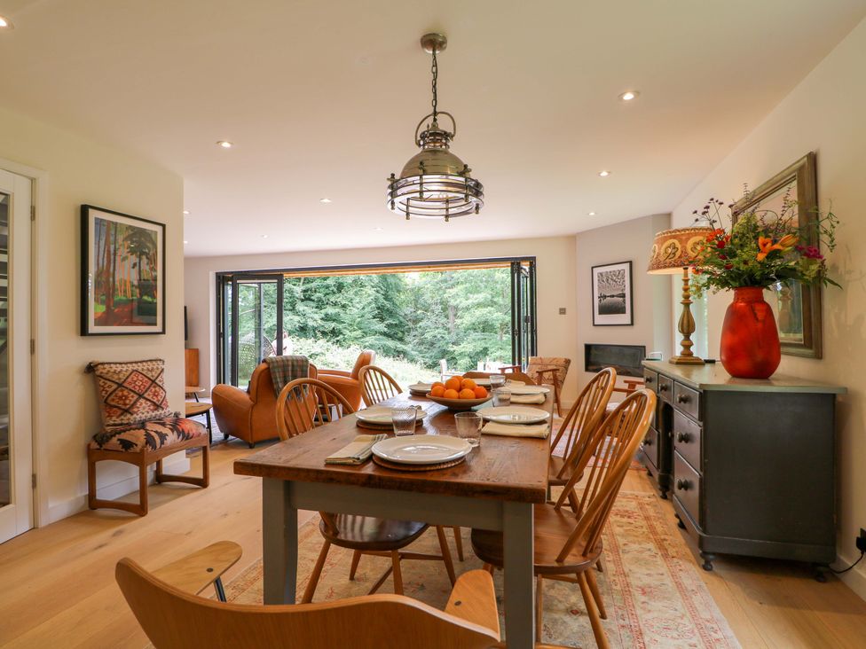 A dining room with a table and chairs at Lakeside Lodge Witherenden Hill near Burwash