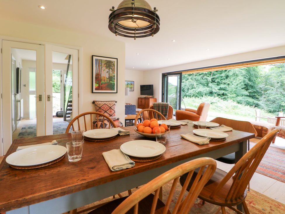 A dining room with a table set for meals at Lakeside Lodge Witherenden Hill near Burwash