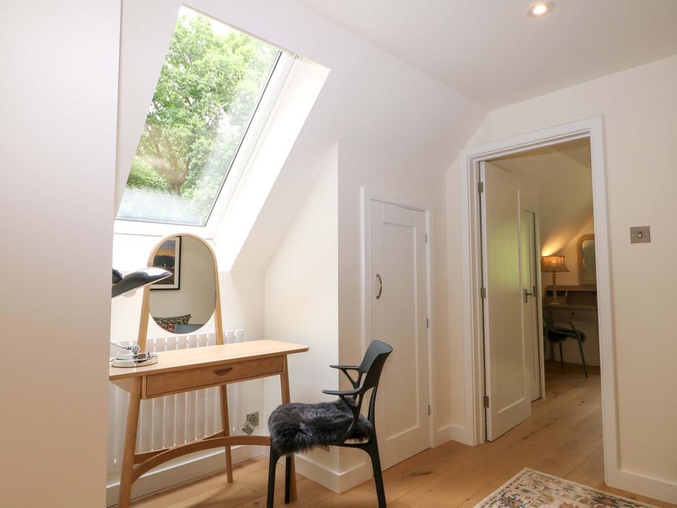 A bedroom with a desk and a chair at Lakeside Lodge in Witherenden Hill near Burwash