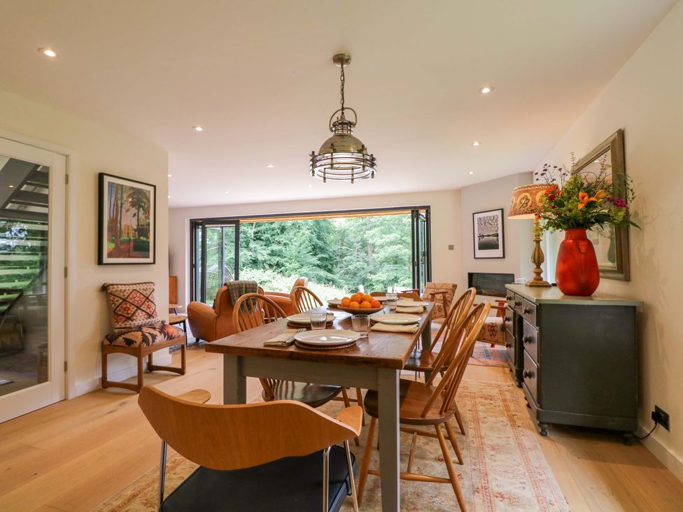 A dining room with a table and chairs at Lakeside Lodge Witherenden Hill near Burwash