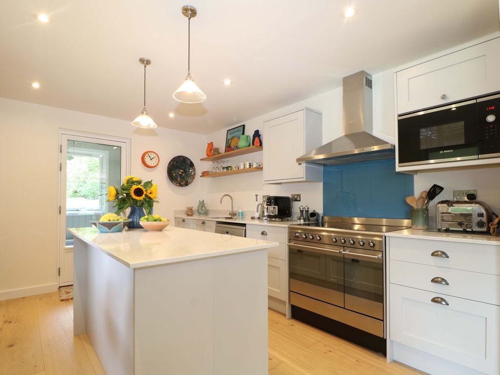 A kitchen with an island and utensils at Lakeside Lodge in Witherenden Hill near Burwash