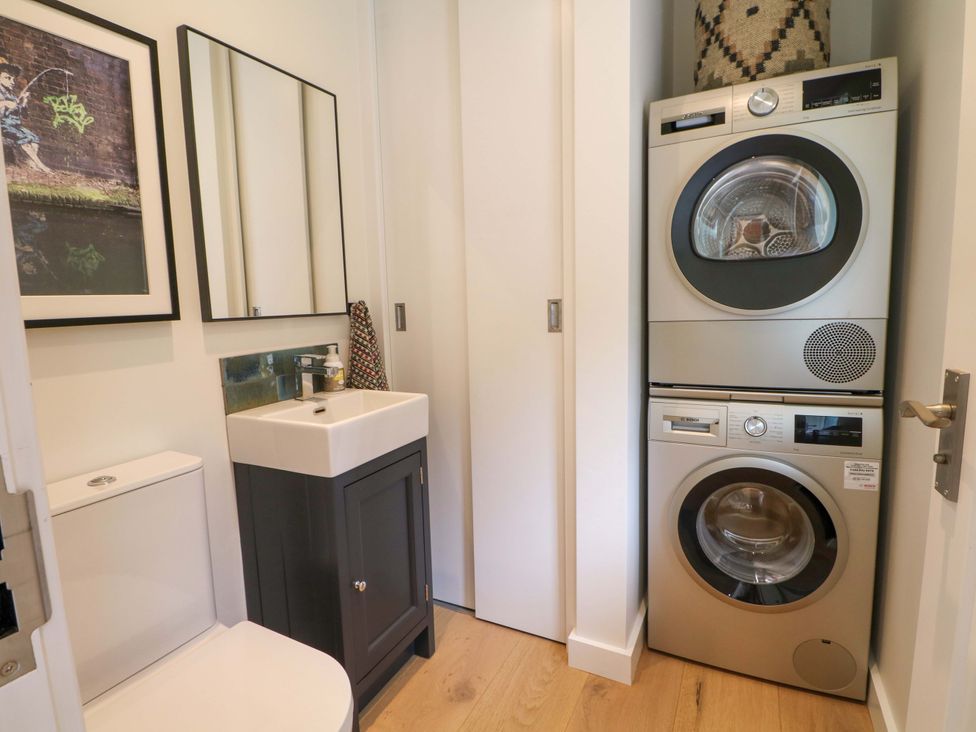 A laundry room with a washer and dryer at Lakeside Lodge Witherenden Hill near Burwash