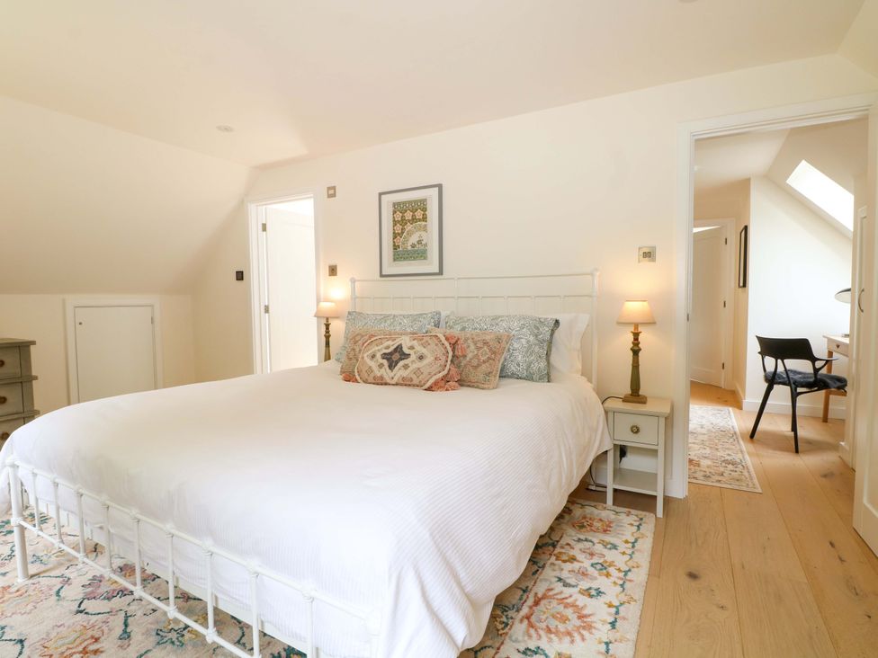 A bedroom with a bed and nightstand at Lakeside Lodge Witherenden Hill near Burwash