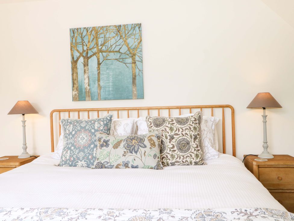 A bedroom with a bed and pillows at Lakeside Lodge Witherenden Hill near Burwash