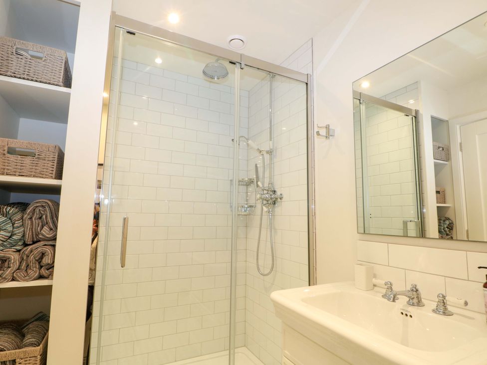 A bathroom with a shower and sink at Lakeside Lodge Witherenden Hill near Burwash