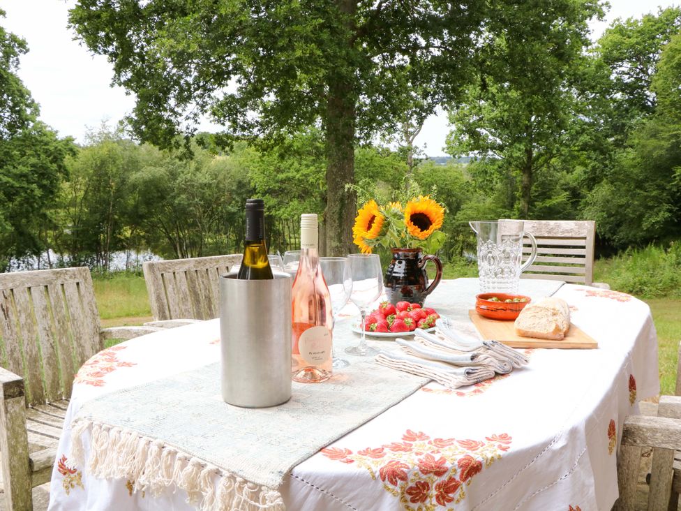 A table set with wine and food at Lakeside Lodge in Witherenden Hill near Burwash