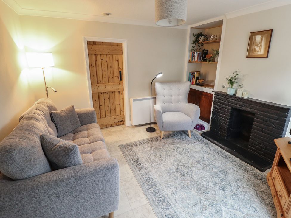 A living room with a sofa and armchair at Conisholme in North Thoresby