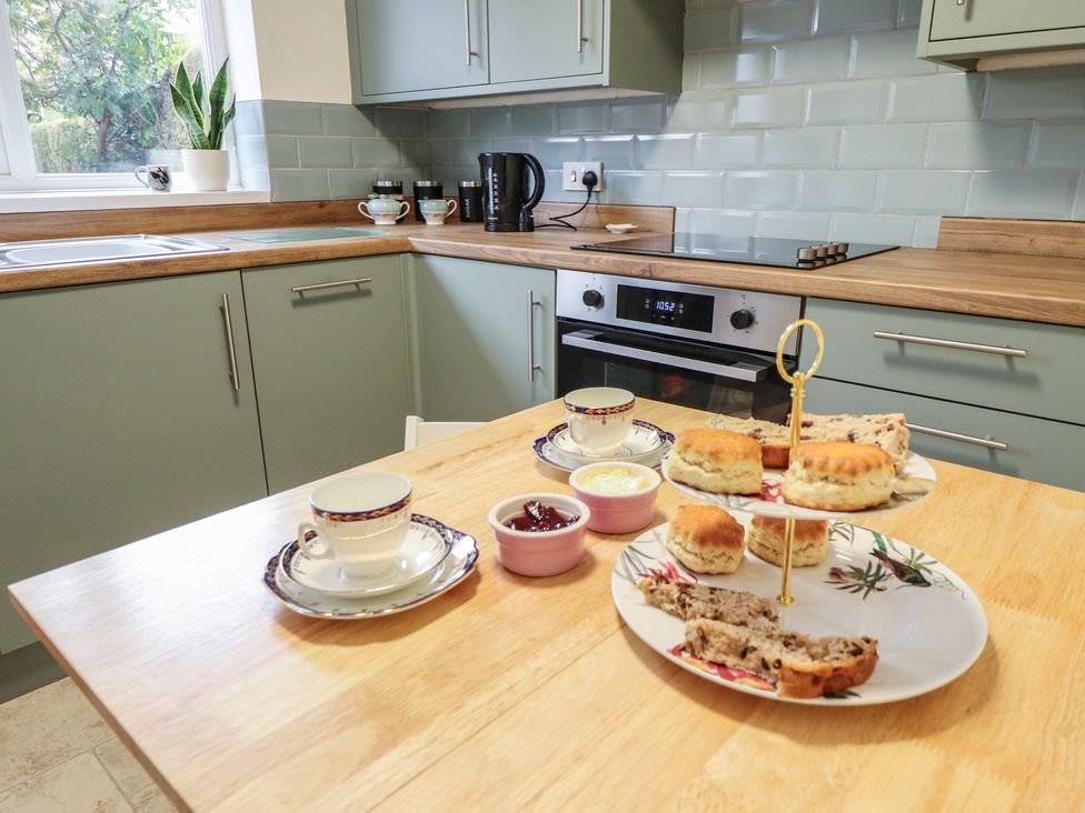 A kitchen with a dining table set for tea at Conisholme in North Thoresby