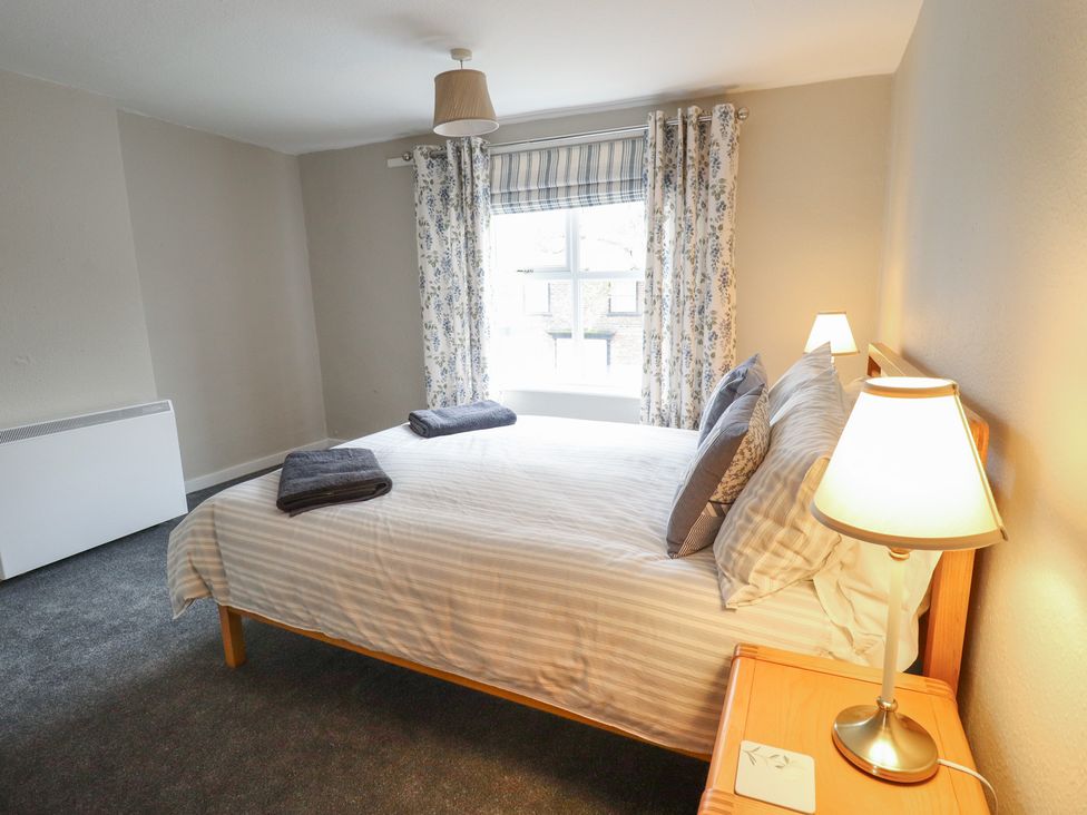 A bedroom with a bed and lamp at Conisholme in North Thoresby