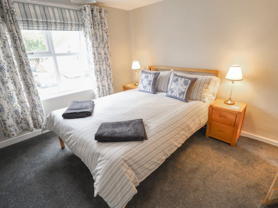 A bedroom with a bed and bedside table at Conisholme in North Thoresby