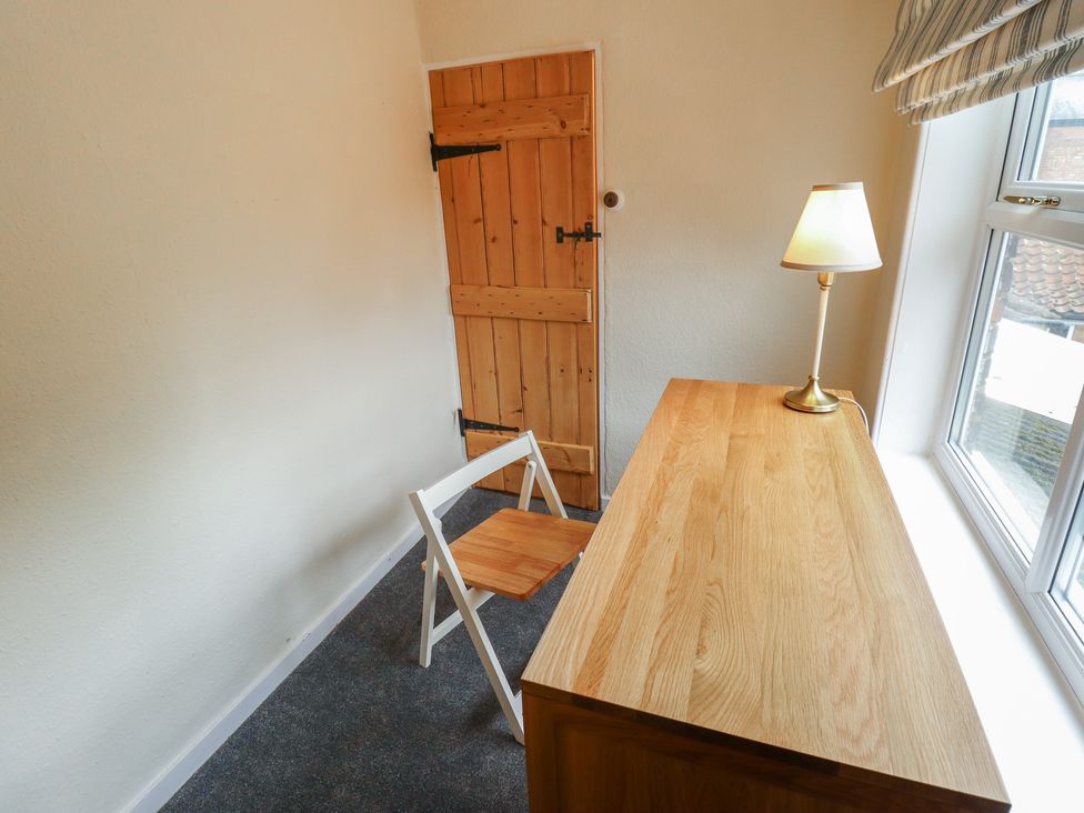 A workroom with a table and chair at Conisholme in North Thoresby