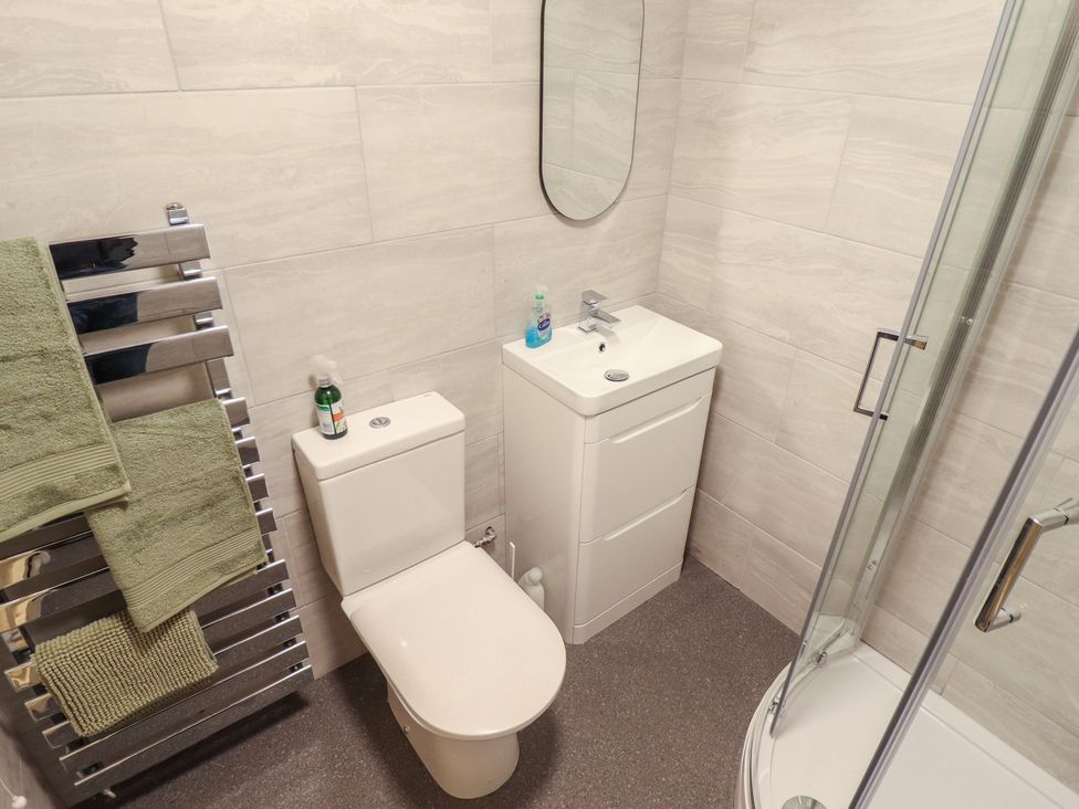 A bathroom with a toilet, sink, and shower at Conisholme in North Thoresby