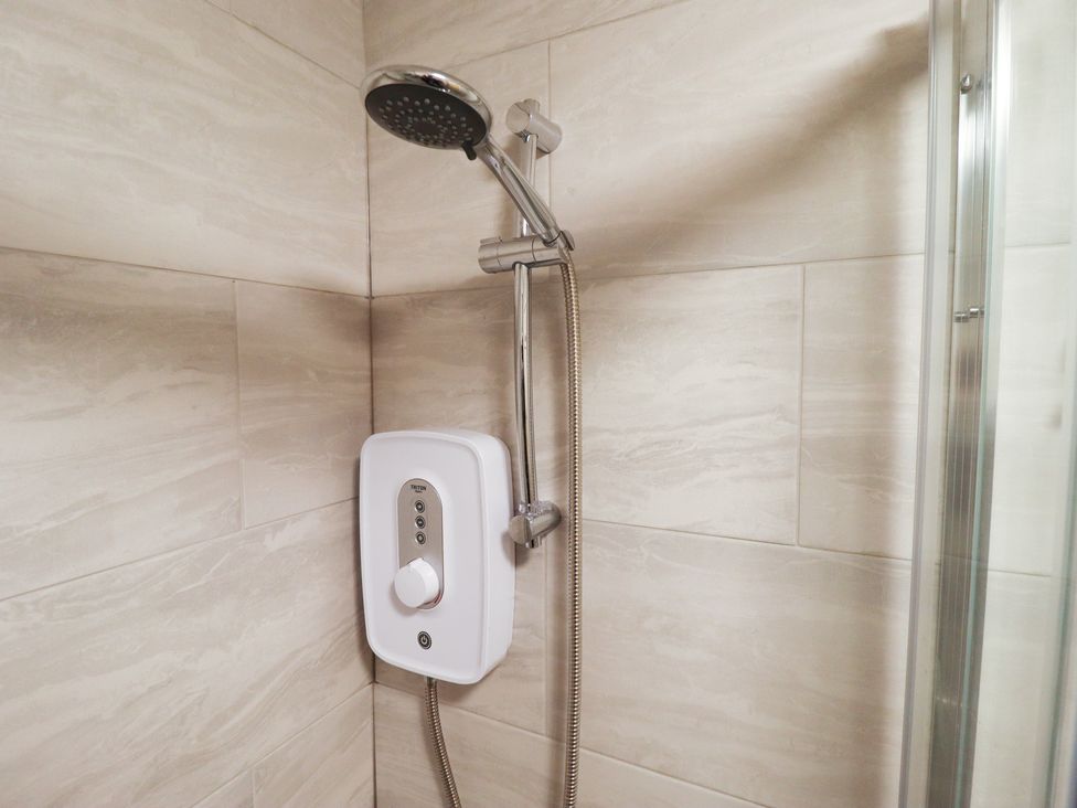 A shower with a head and control unit at Conisholme North Thoresby