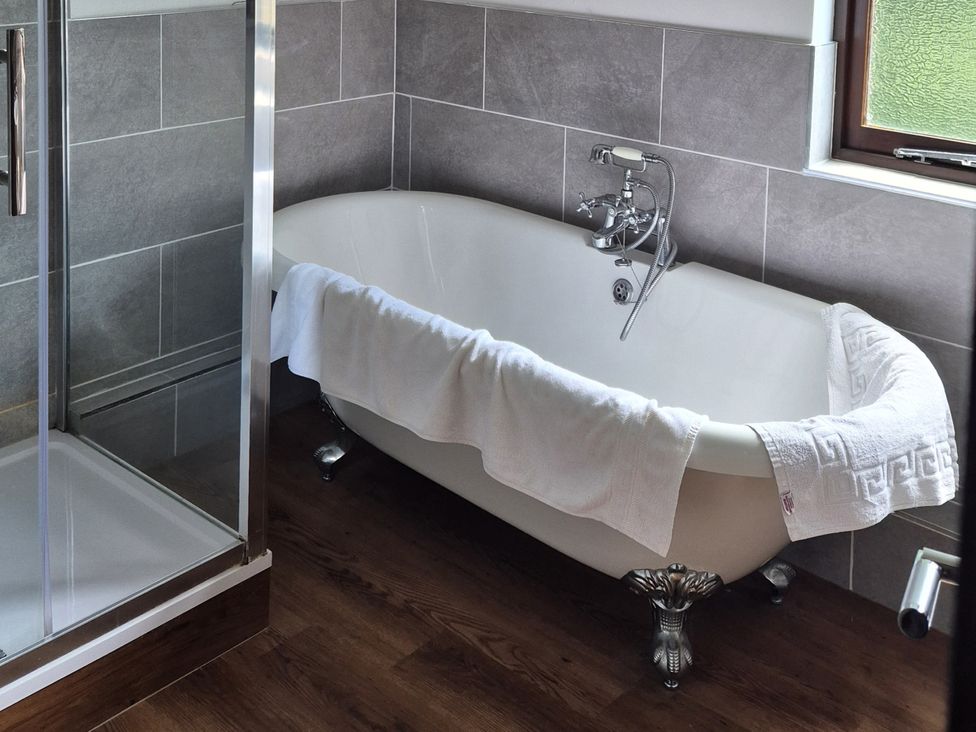 A bathroom with a bathtub and shower at Flat 3, The Old Bakehouse in Telford