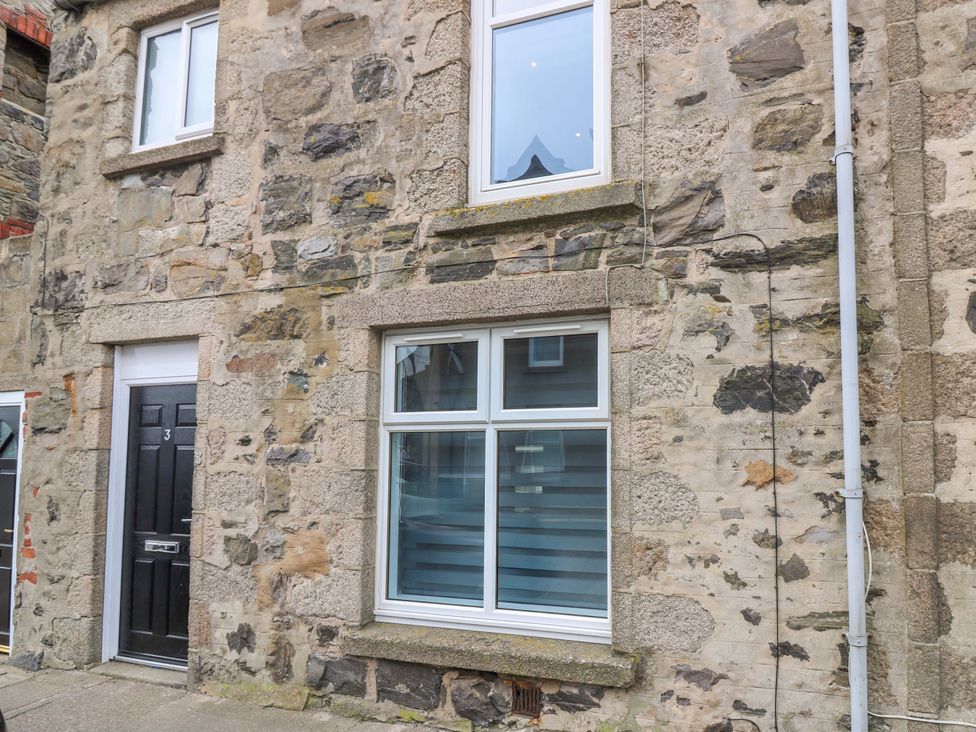 An exterior view of a stone building with a door and windows at 3 Caroline Place Fraserburgh