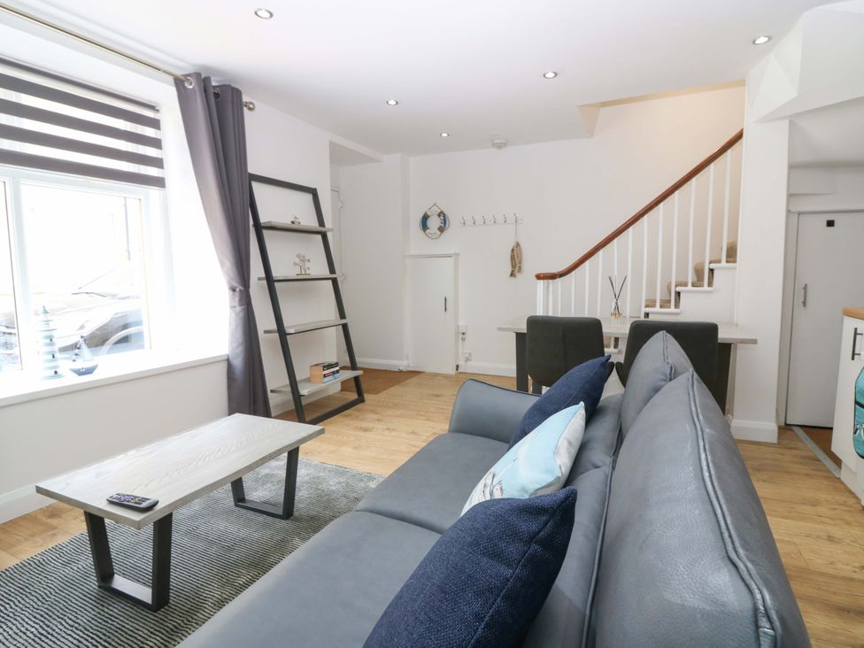 A living room with a sofa and shelf at 3 Caroline Place in Fraserburgh