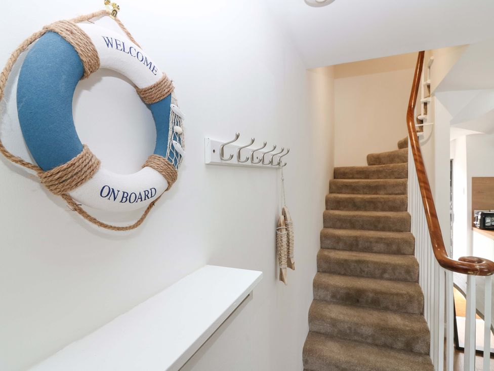 A hallway with a lifebuoy and hooks at 3 Caroline Place Fraserburgh