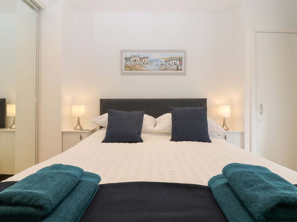 A bedroom with a bed and lamps at 3 Caroline Place in Fraserburgh