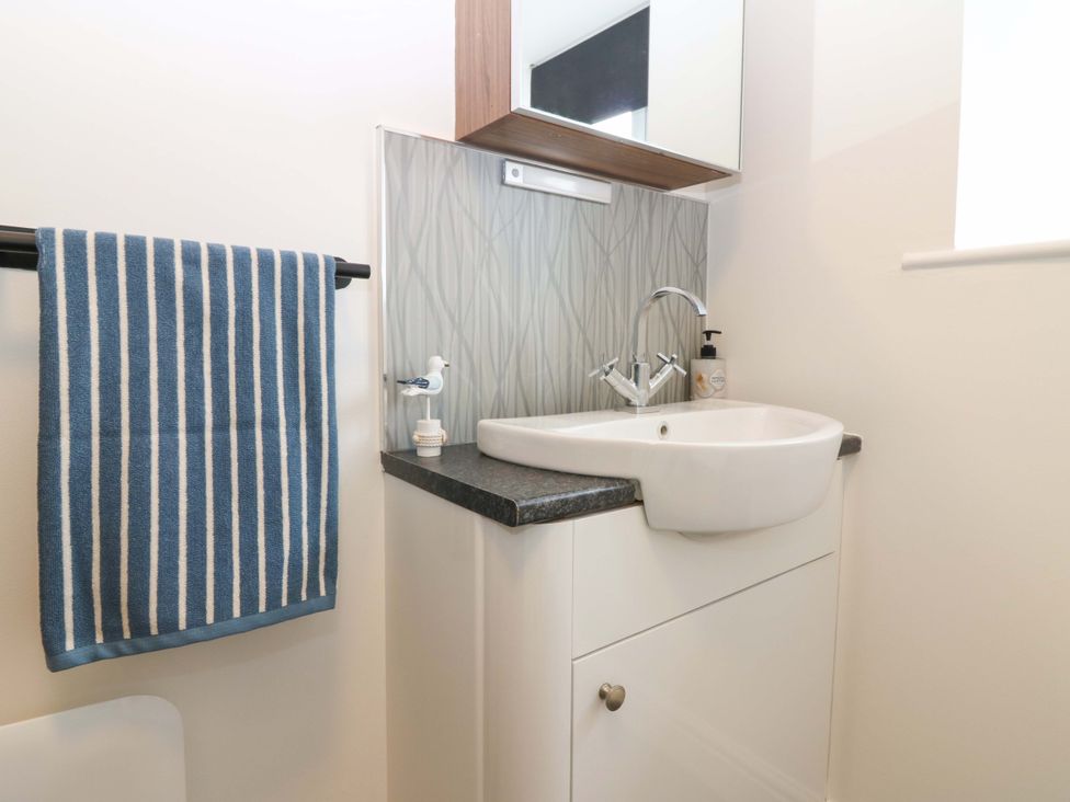 A bathroom with a sink and mirror at 3 Caroline Place in Fraserburgh
