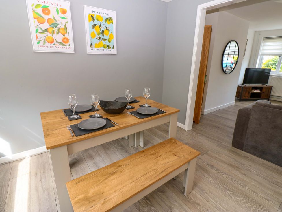 A dining area with a table set for meals at 8 Shearwater Way in Blyth