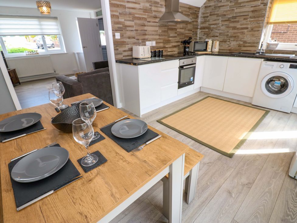 A kitchen with dining table and chairs at 8 Shearwater Way Blyth