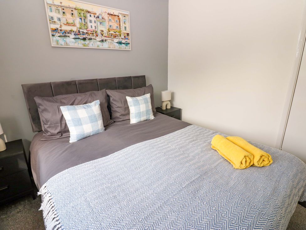 A bedroom with a bed and decorative pillows at 8 Shearwater Way in Blyth