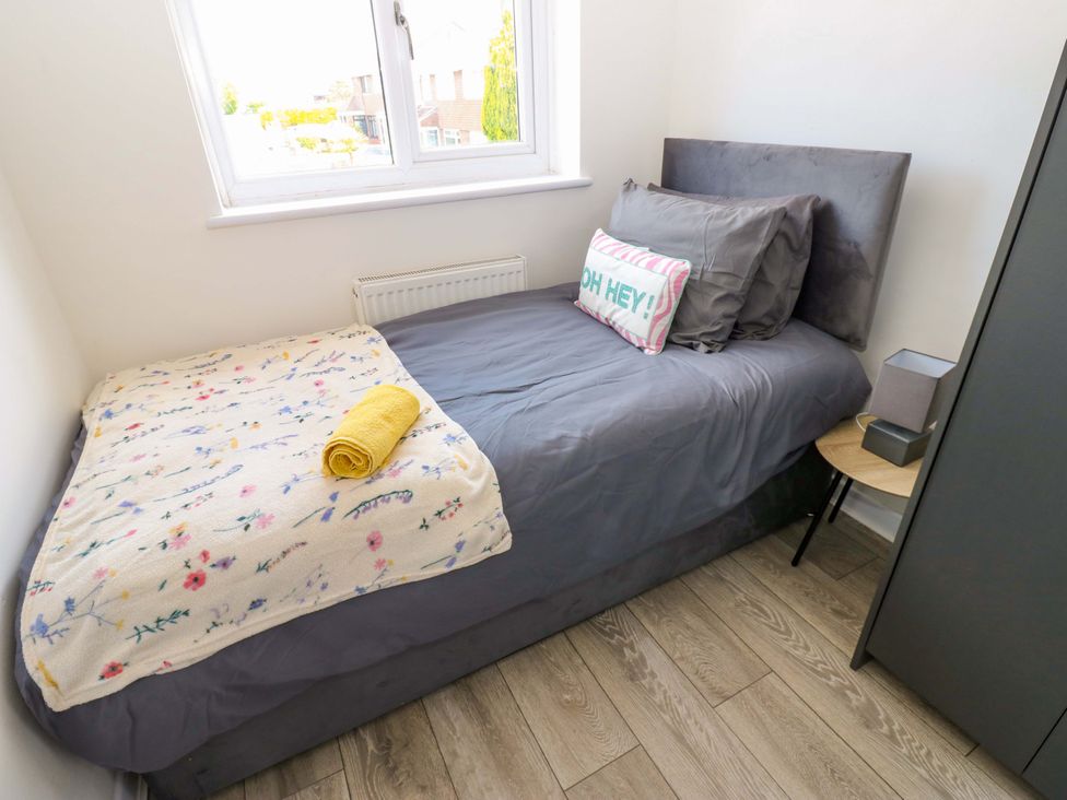 A bedroom with a single bed and nightstand at 8 Shearwater Way in Blyth