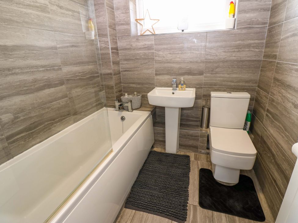 A bathroom with a bathtub, toilet, and sink at 8 Shearwater Way Blyth