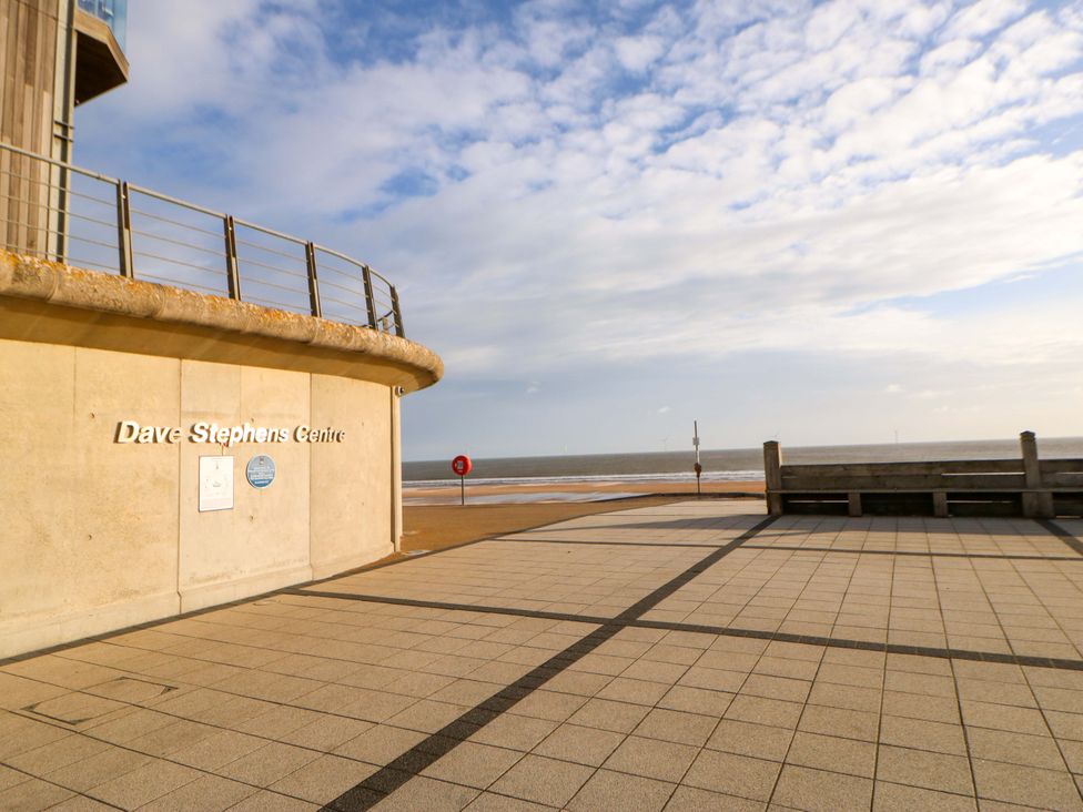 A seaside view with a building facade and sign at 8 Shearwater Way Blyth