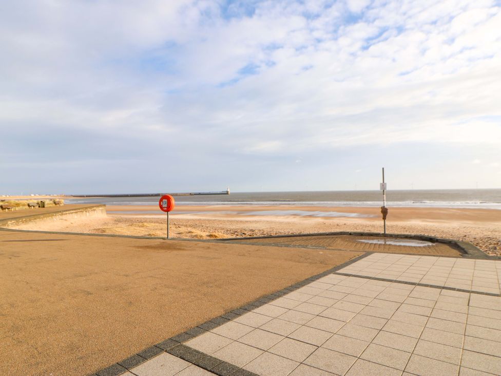A beach with a lifebuoy and pavement at 8 Shearwater Way in Blyth