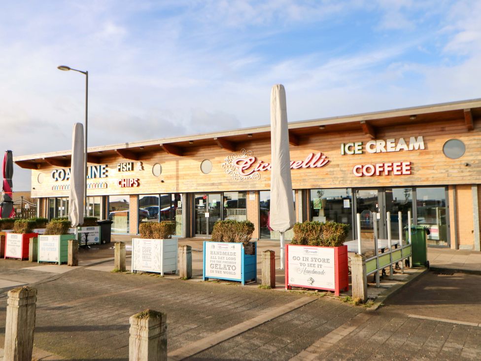A restaurant exterior with signage and outdoor seating at 8 Shearwater Way Blyth