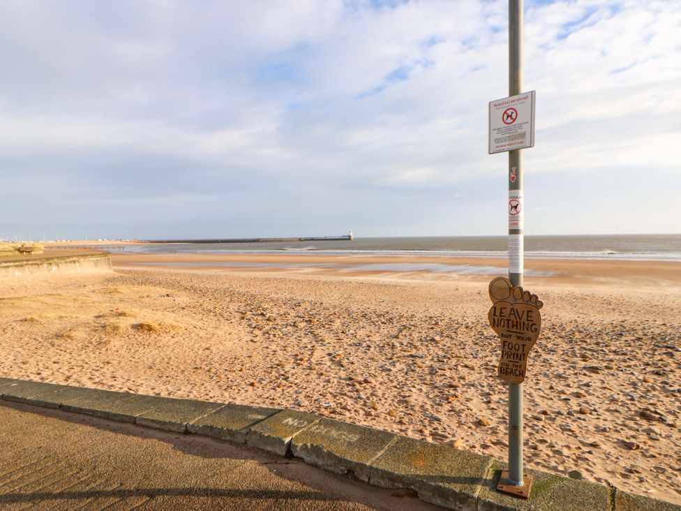 A beach with a sign post at 8 Shearwater Way in Blyth