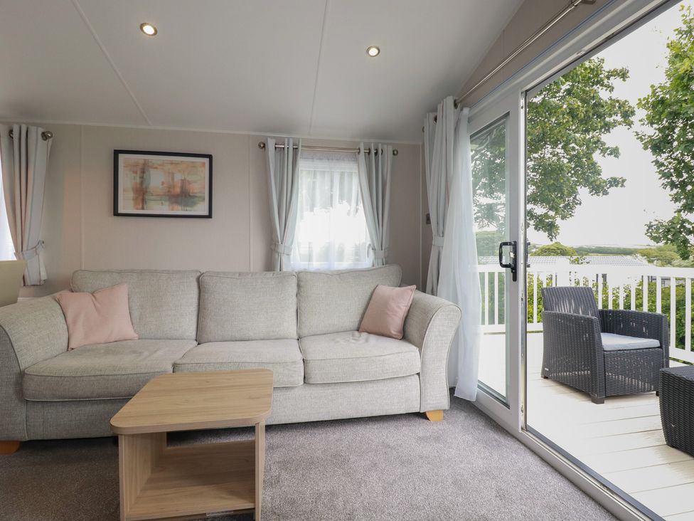 A living room with a sofa and coffee table at The Maples, no. 56 Hewas Water near Polgooth