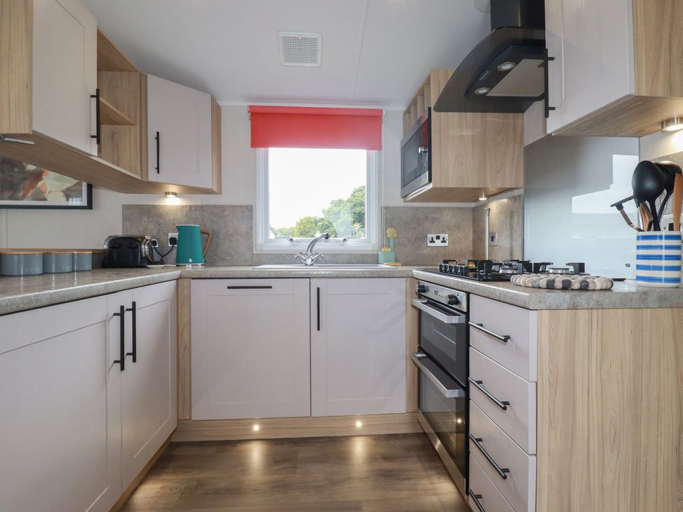 A kitchen with cabinets and appliances at The Maples, no. 56 Hewas Water near Polgooth