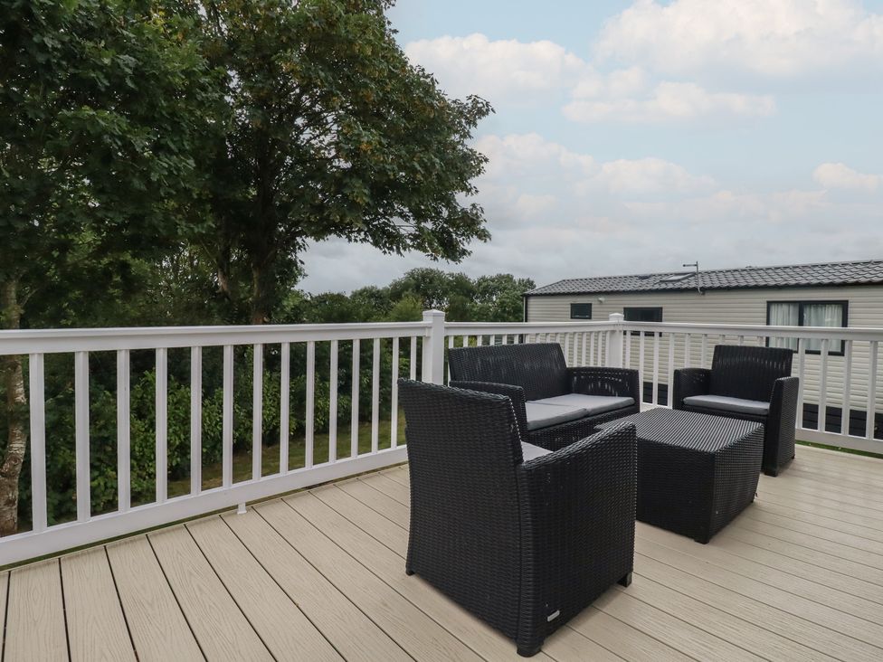 An outdoor seating area with chairs and a table at The Maples, no. 56 Hewas Water near Polgooth