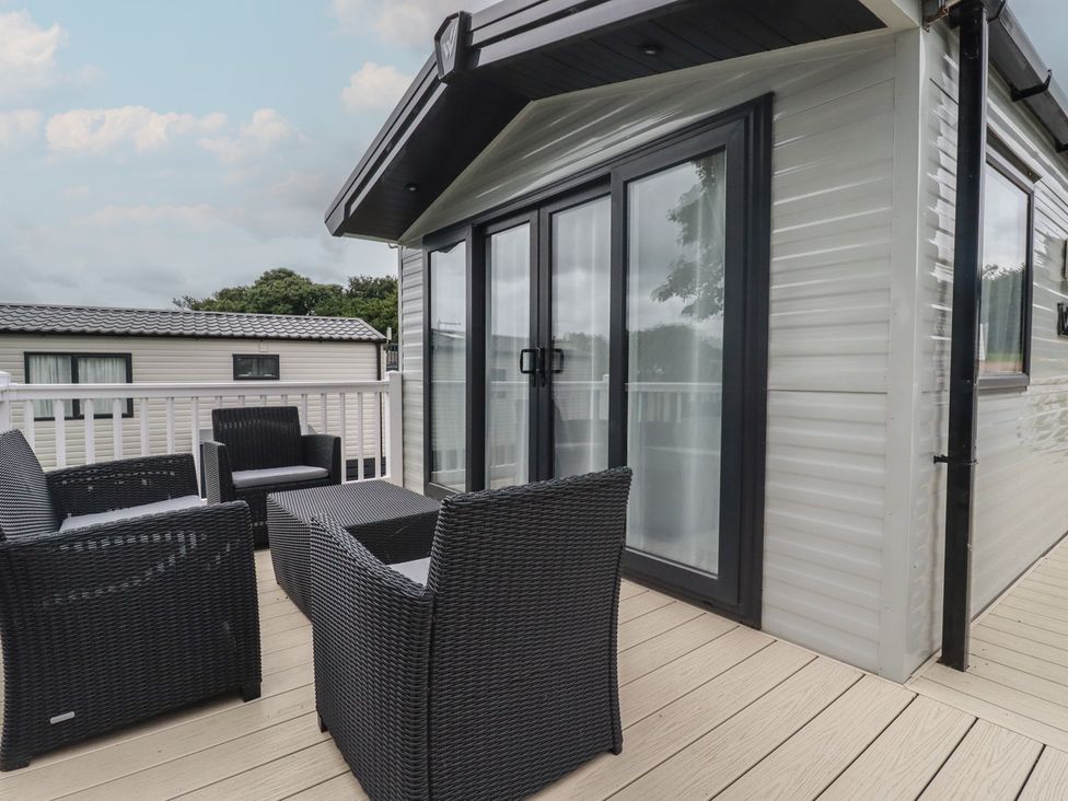 A balcony with seating and sliding doors at The Maples, no. 56 Hewas Water near Polgooth