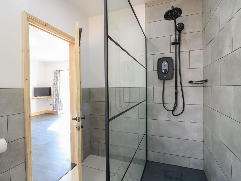 A bathroom with a shower and a door at Annex studio 2 Northampton