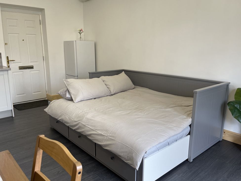 A bedroom with a bed and fridge at Daffodil in Northampton