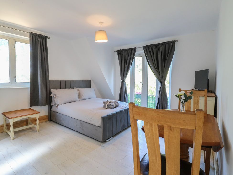 A bedroom with a bed and a table at Sunflower in Northampton