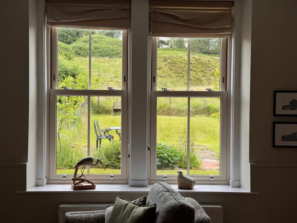 A living room window overlooking a garden at Old Station Cottage in Hexham