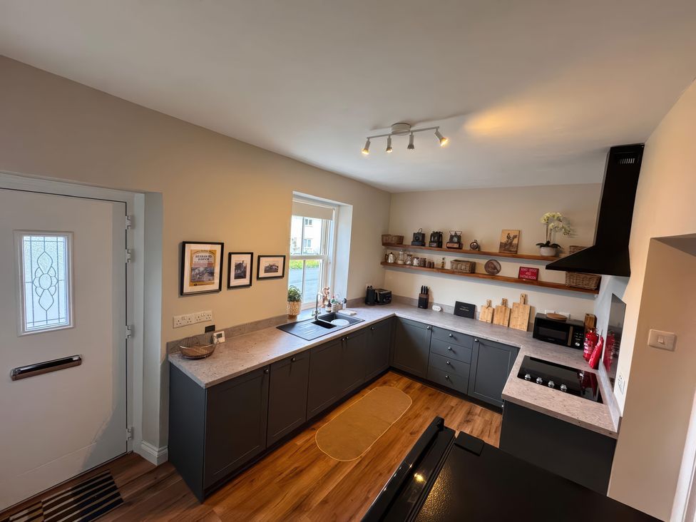 A kitchen with sink and cabinets at Old Station Cottage in Hexham