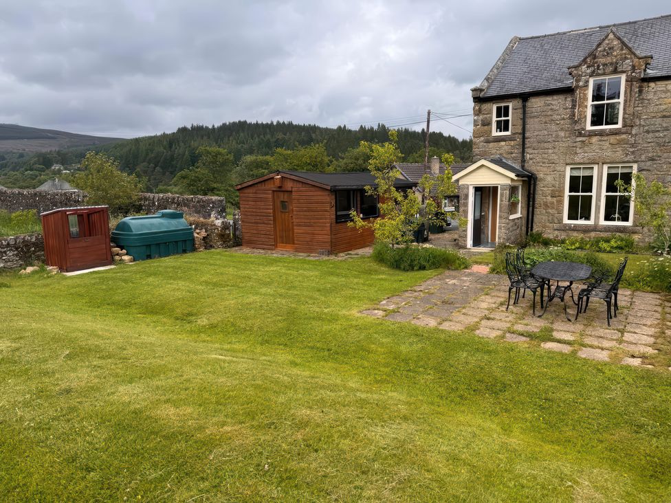 A garden with a shed and water tank at Old Station Cottage Hexham