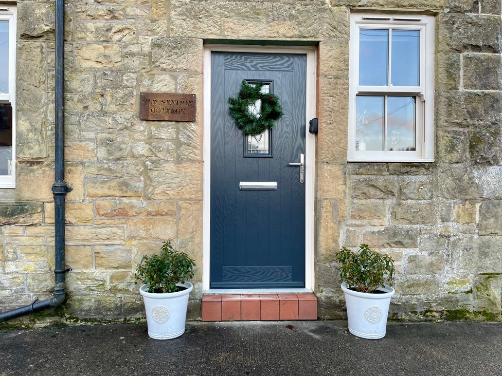 An entrance with a door and plants at Old Station Cottage in Kielder