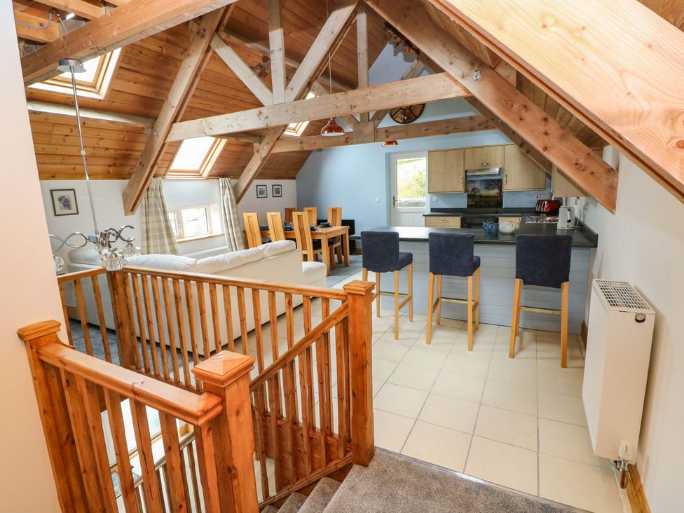 A living room with a dining area and kitchen at Pendre Barn Llanfyrnach
