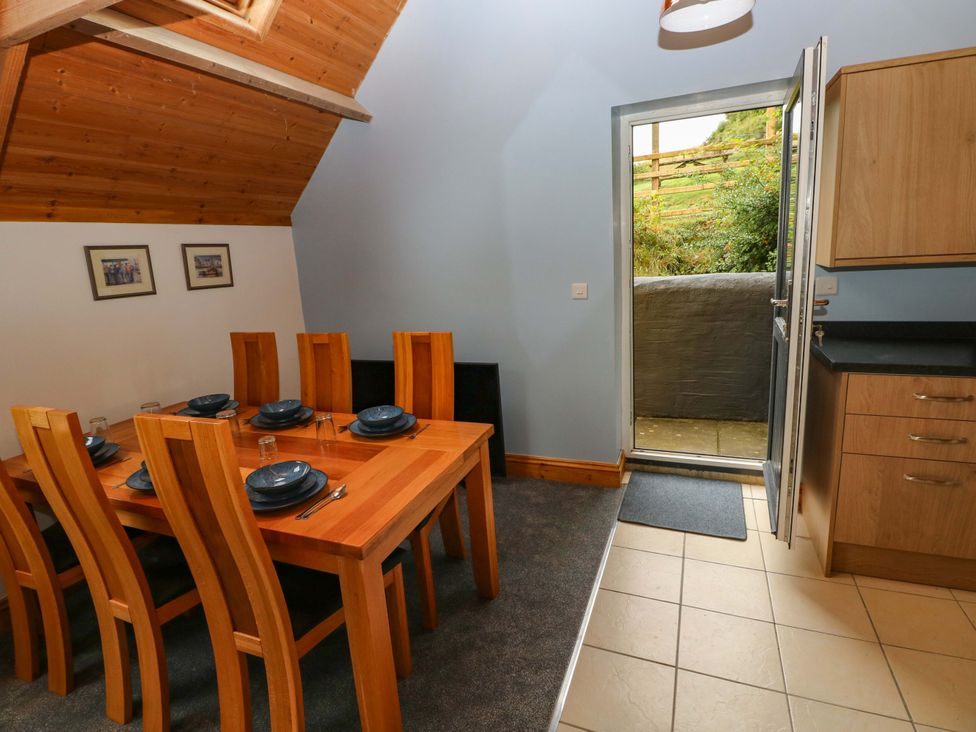 A dining area with a table and chairs at Pendre Barn Llanfyrnach