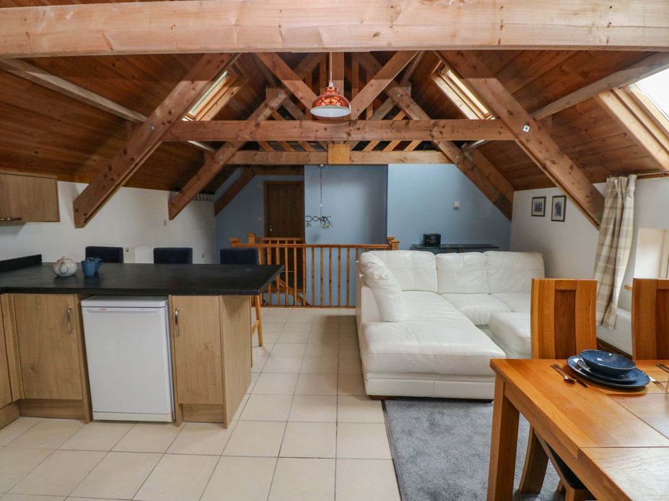 A living room with a kitchen and dining area at Pendre Barn Llanfyrnach