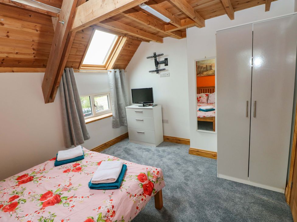 A bedroom with a bed and television at Pendre Barn Llanfyrnach