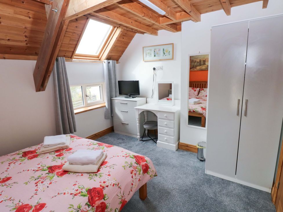 A bedroom with a bed and desk at Pendre Barn Star near Cenarth
